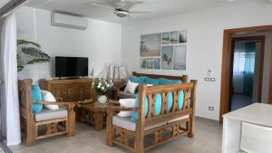 a living room with a couch and a table and chairs at Nicole Residence in Las Terrenas