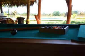 a box of cue balls on a pool table at Casa Roja Hostel in Montañita