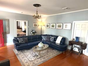 a living room with a blue couch and a table at Blue Ruby Inn in Elizabeth City