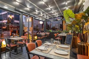 a dining room with tables and chairs and windows at Garner Hotel Istanbul - Airport Arnavutkoy by IHG in Istanbul