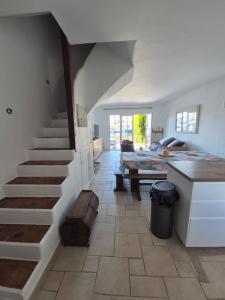 a room with a staircase and a living room at Fisherman's house in Port Grimaud in Grimaud