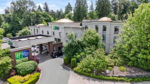 an aerial view of a hotel with a parking lot at Holiday Inn Express and Suites Surrey by IHG in Surrey