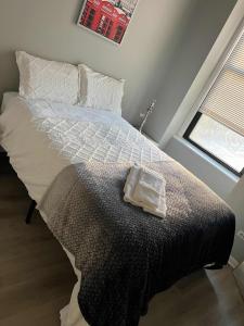 a bedroom with a bed with a towel on it at South Loop 2 Bedroom Apt in Chicago