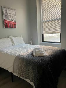 a bedroom with a bed with a towel on it at South Loop 2 Bedroom Apt in Chicago +22 photos