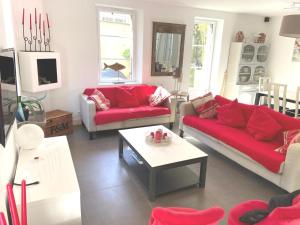 a living room with two couches and a table at Villa Ker Zen 300m de la plage in La Baule