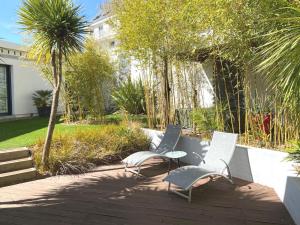 a group of chairs and a table in a garden at Villa Ker Zen 300m de la plage in La Baule