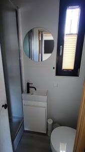 a bathroom with a white toilet and a mirror at Houseboat SeeSea Mazury - Domek na wodzie Bogaczewo k Giżycka in Bogaczewo +26 photos