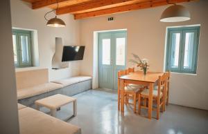 a living room with a table and a couch at Maira Arch House in Potamós