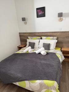 a bedroom with a large bed with yellow and white pillows at Appartement Des Iles in Juan-les-Pins