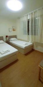 a room with two beds and a window at EnFOZ Playa A Rapadoira in Foz