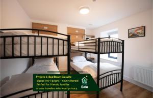 two bunk beds in a room with a green sign at Éalú Lodge in Sligo