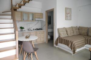 a small bedroom with a bed and a table at PAVEL apartments near airport in Artemida