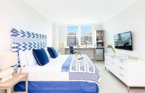 a bedroom with a blue and white bed and a tv at MVR Not a normal suite-An Elevated Miami Stay in Miami