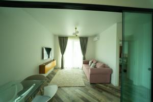 a living room with a couch and a window at CristAlex Sunset in Constanţa