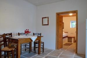 a dining room with a table and chairs in a room at Theodoti in Agia Theodoti