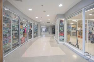 a store aisle with glass doors and shelves of products at Girasole Suites in Miami Beach