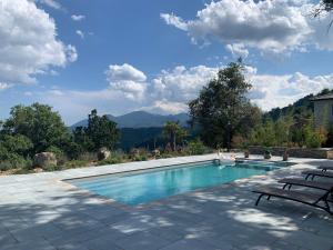 a swimming pool with a view of the mountains at Villa H in Casanova