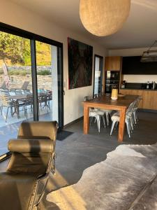 a living room with a wooden table and chairs at Villa H in Casanova
