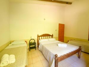 a room with two beds in a room at El Solar Casas de Campo 2 in Valle Grande +26 photos