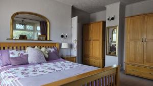 a bedroom with a bed and a large mirror at Westend House in Goring by Sea