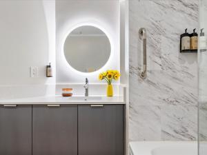 a bathroom with a sink and a mirror at MVR Don-t Miss Out on This Luxury Suite in Miami +14 photos