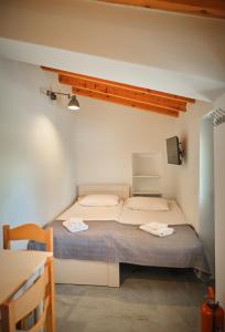 a bedroom with a large bed in a room at Maira Arch House in Potamós