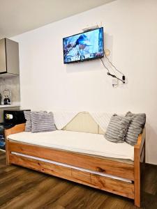 a bed in a room with a tv on the wall at Condo in Baguio - Megatower 7 Near SM in Baguio
