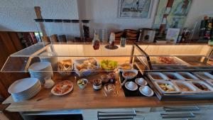 a table with a bunch of food on it at Berggasthof & Hotel Kranich in Eisfeld