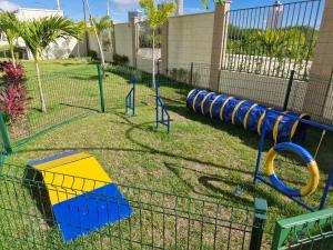 a playground with blue and yellow equipment in a park at Cantinho das bromélias in Caruaru