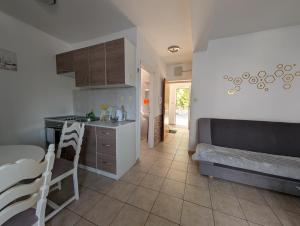 a kitchen and a living room with a bed and a table at Apartman Viva Family in Baška Voda