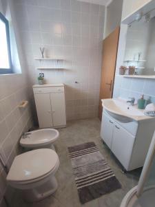 a bathroom with a toilet and a sink at Apartman Sunce in Ogulin +61 photos