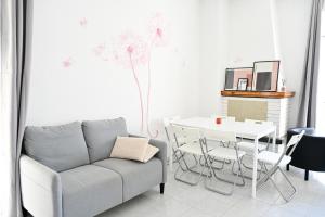 a living room with a couch and a table at Sognando Varenna-Lake Como View- in Fiumelatte