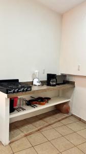 a kitchen with a counter with a bunch of utensils at Beautiful comfortable apartment in Tuxpan de Rodríguez Cano +7 photos