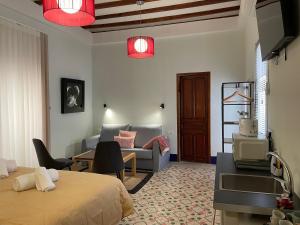 a bedroom with a bed and a living room at La Casa del Médico in Pego