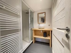 a bathroom with a sink and a glass shower at Chalet de standing avec sauna et cheminée, 10 pers - FR-1-505-34 in Notre-Dame-de-Bellecombe +16 photos