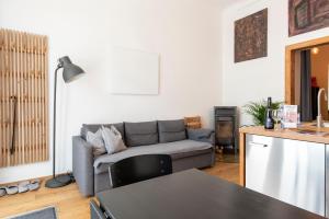 a living room with a couch and a table at Zentrales & modernes City-Apartment in Graz +21 photos