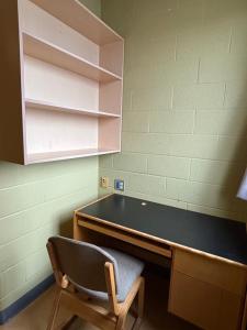 a desk with a chair sitting next to a desk at Hotel Laurier - King Street Residence in Waterloo