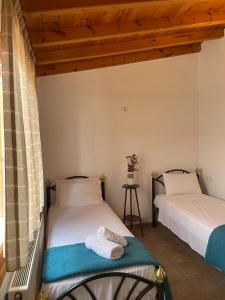 two beds in a room with a window at Lula's House in Skiathos Town