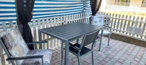 a table and two chairs on a balcony at Gabriel in Sofia Rezidence in Saturn