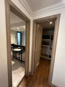 a room with a kitchen with a table and a doorway at Hotel Vintage in Bogotá