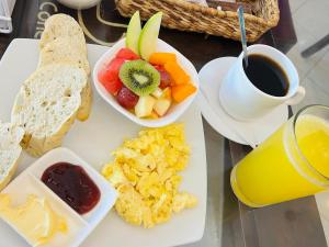 a breakfast tray with a plate of food and a cup of coffee at Hotel Sierra Negra in Puerto Villamil