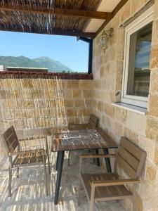 a table and chairs on a patio with a view at Mila in Danilovgrad