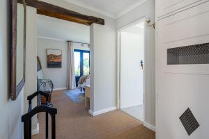 a hallway with a door leading to a living room at Libertas House, Cheverells Farm in Grabouw