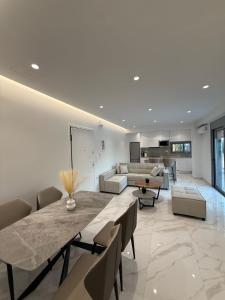 a living room with a dining table and a couch at Toska Residence in Loutraki