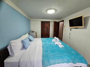 a bedroom with a bed with a towel on it at Hello Jomtien in Jomtien Beach