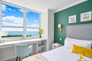 a bedroom with a bed and a desk and a window at MVR Suite Where Your Miami Memories Begin in Miami