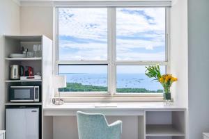 a window in a kitchen with a desk and a microwave at MVR Suite Where Your Miami Memories Begin in Miami