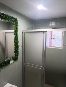 a bathroom with a shower with ivy on the wall at Hotel Palma Paraíso in Melgar +29 photos
