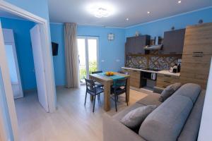 a living room with a couch and a table at mimma's home in Castelmola