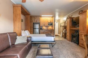 a living room with a bed and a leather couch at 132 Bldg C condo in Truckee
